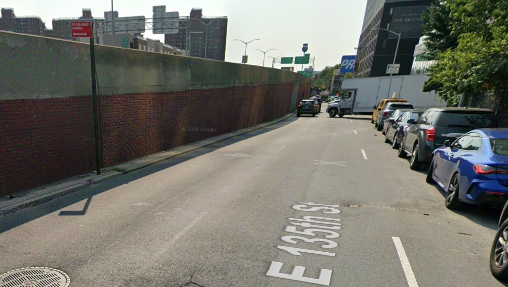 E 135th Street beside the Deegan retaining wall, with The Motto building across the way.